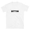 White t-shirt with bold "BOTTOM" text, perfect for gay pride apparel.