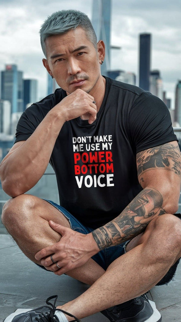 Model in black shirt with 'Don't Make Me Use My Power Bottom Voice' graphic, showcasing funny gay shirt.