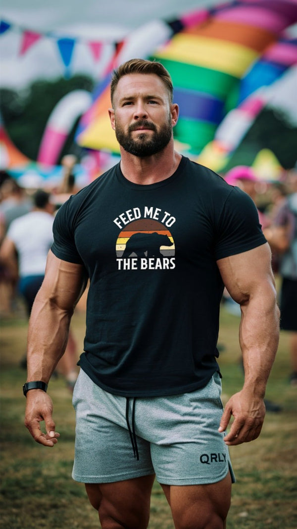 Muscular man wearing a Feed Me To The Bears Gay Bear Tshirt at a pride event.