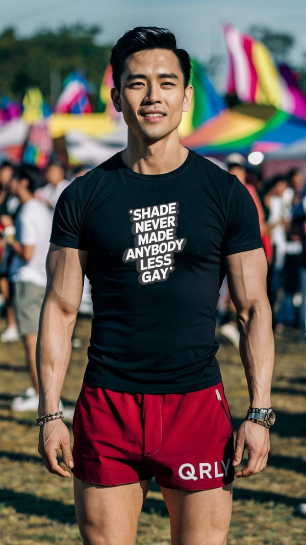 Man wearing a black funny gay shirt, showcasing LGBTQ pride at a festival.