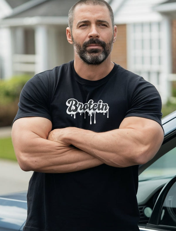 Model wearing a black funny gay T-shirt - Brotein with bold graphics.