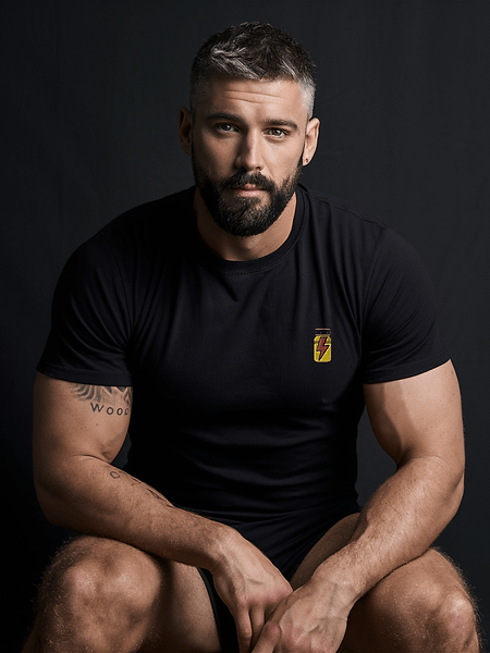 Model wearing a dark gay shirt, showcasing muscular build and stylish design.
