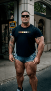 Muscular man in gay bear shirt, wearing sunglasses, showcasing pride apparel.