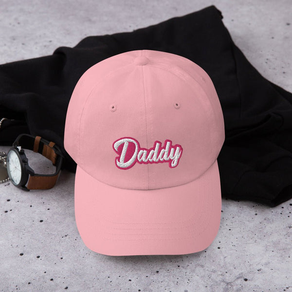 Gay Dad cap Gay Daddy hat with embroidered 'Daddy' in pink on a casual backdrop.
