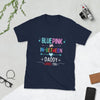 Navy blue LGBTQ shirt with colorful text: 'Blue, Pink or In-Between, Daddy Loves You'