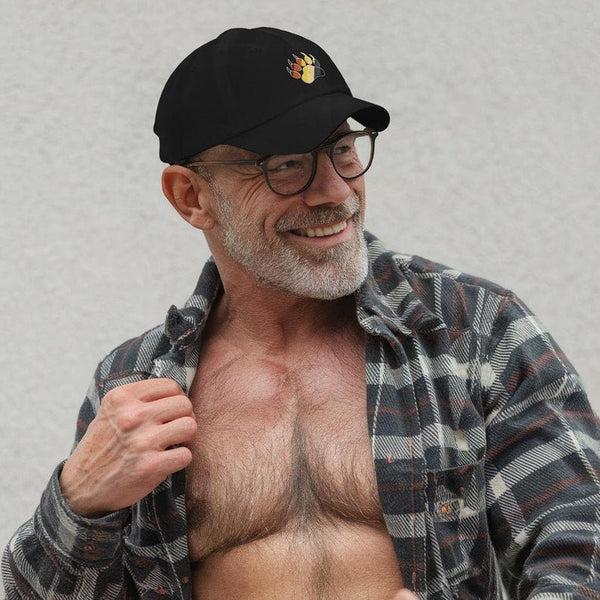Gay Pride Bear Bear Paw Hat worn by a smiling man in casual attire.