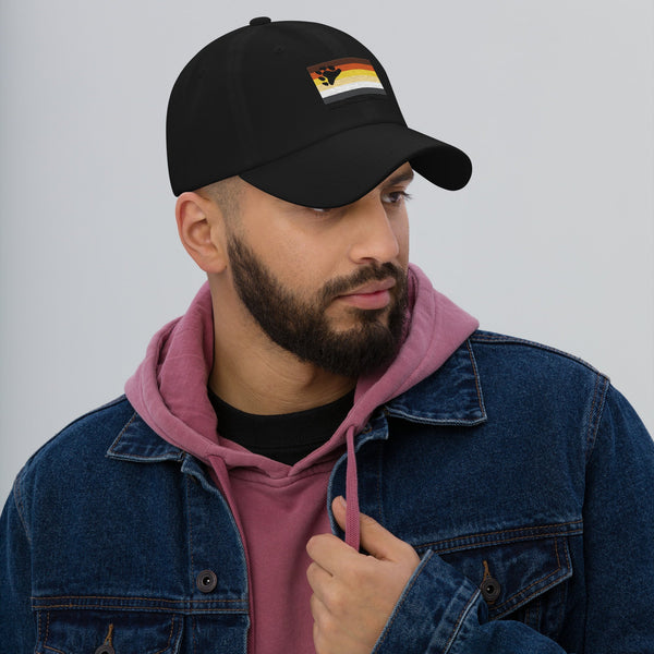 Black hat with gay pride bear paw graphic, worn by model.