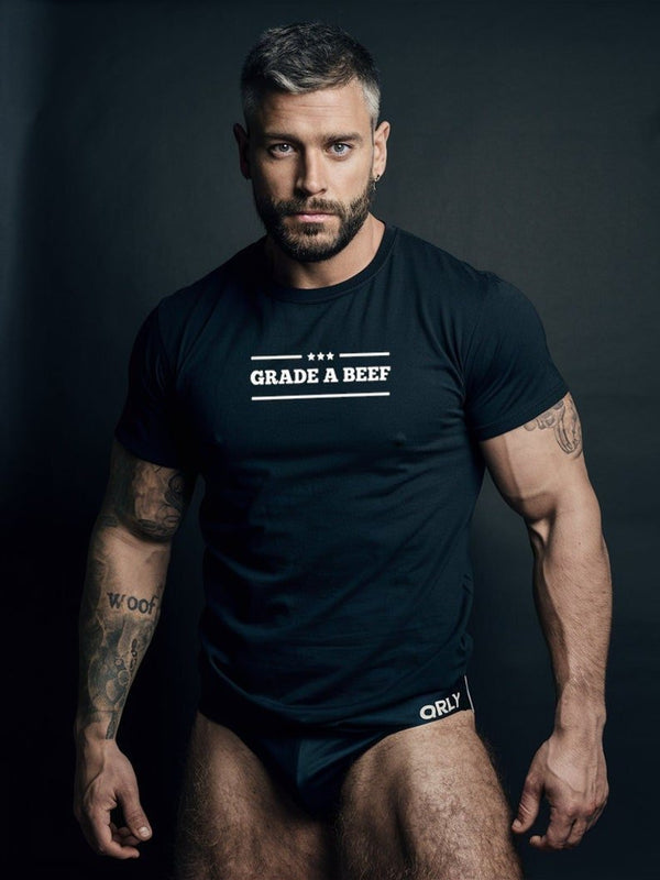 Muscular model wearing Grade A Beef Flag Shirt from gay pride apparel collection.