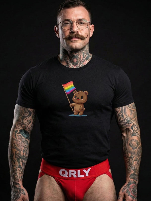 Muscular man wearing black gay bear pride shirt with rainbow flag design.