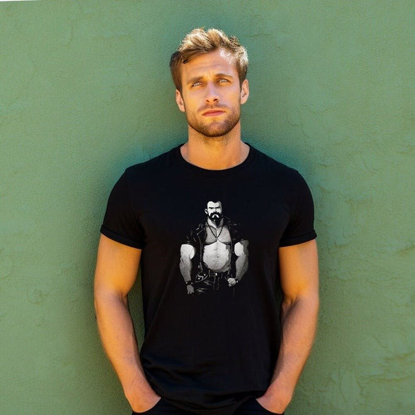 Model wearing a black shirt featuring a vintage muscle bear graphic, LGBTQ pride apparel.