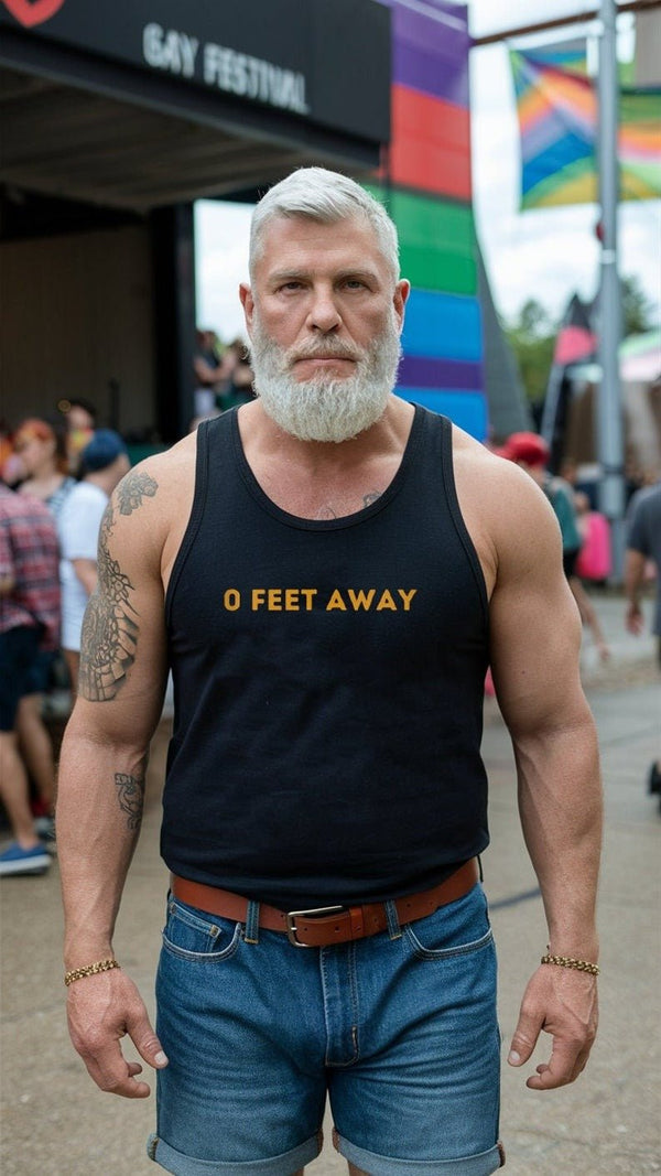 Muscular man in black tank top reading '0 Feet Away' at a gay pride festival.