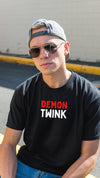 Young man wearing black t-shirt with 'Demon Twink Funny Gay Pride Tee' design.