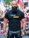 Man wearing a funny gay shirt featuring Grindr conversations at a pride event.