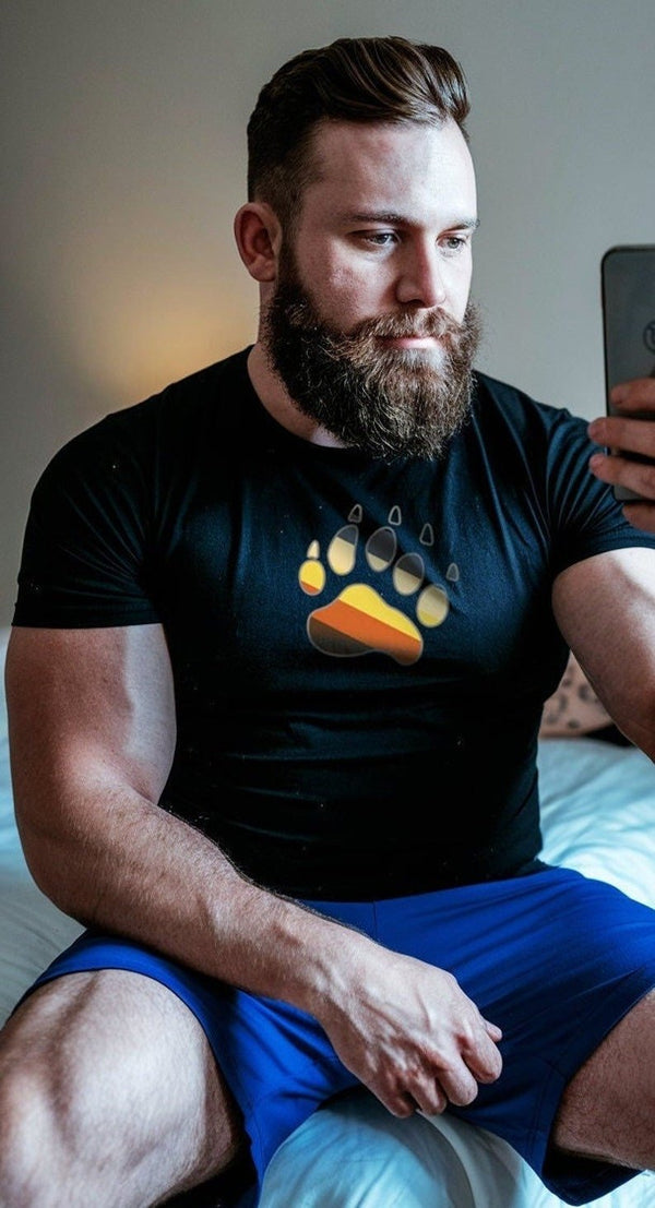 Model wearing a black gay bear shirt with colorful paw print design.