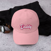 Gay Dad cap Gay Daddy hat with embroidered 'Daddy' in pink on a casual backdrop.