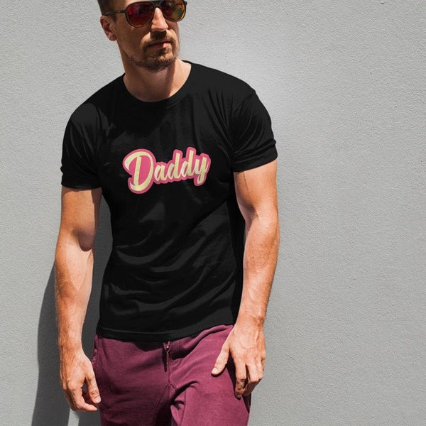 Man in black shirt with 'Daddy' text, showcasing gay dad shirt design.