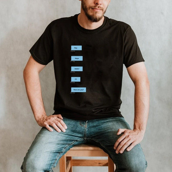 Man in black gay shirt featuring humorous Grindr dialogue text design.