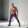 Model wearing Galaxy Nebula Men’s Leggings in purple and blue space print, showcasing fit for gym and pride apparel.