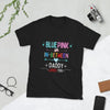 Black shirt with colorful 'Blue Pink or In-Between Daddy Loves You' design, LGBTQ pride apparel.