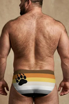 Man wearing a colorful men's underwear with paw print design on a beige background