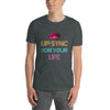 Model wearing a grey gay shirt with colorful 'Lip Sync For Your Life' graphic design.