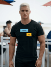 Model wearing Looking? Yep. Grindr Dialogues LGBT Shirt in black, showcasing humor and pride.
