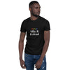 Man wearing a black LGBTQ pride shirt with colorful text design.