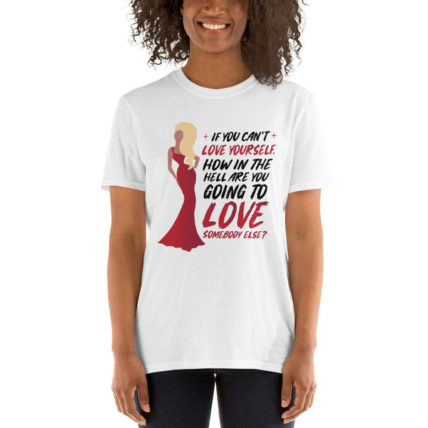 Woman wearing a white gay shirt featuring Ru Paul Love Yourself Quote design.