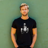Model wearing a black shirt featuring a vintage muscle bear graphic, LGBTQ pride apparel.